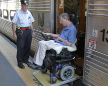 disabled person coming off train